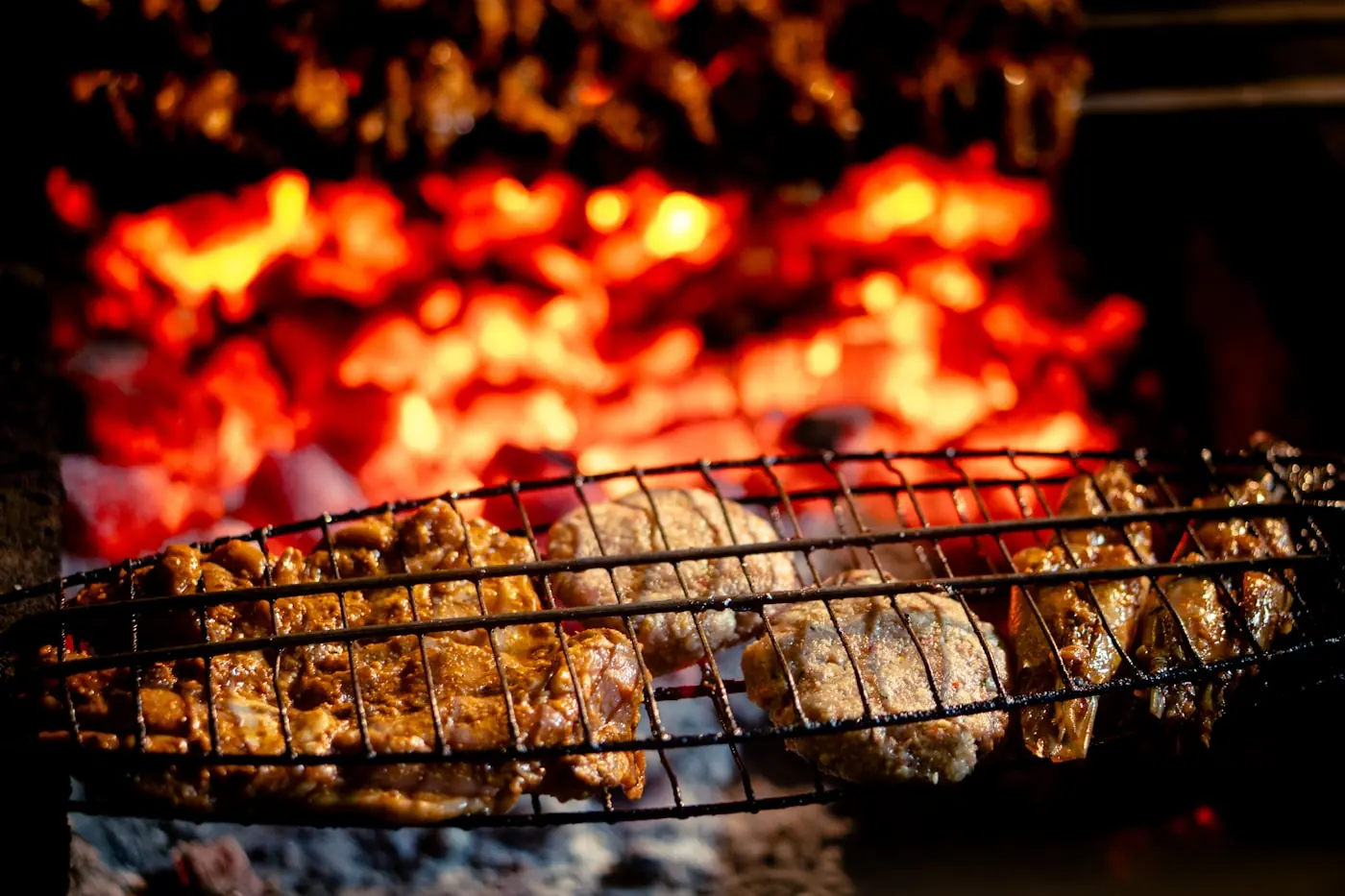 Meat over glowing charcoal in the grill