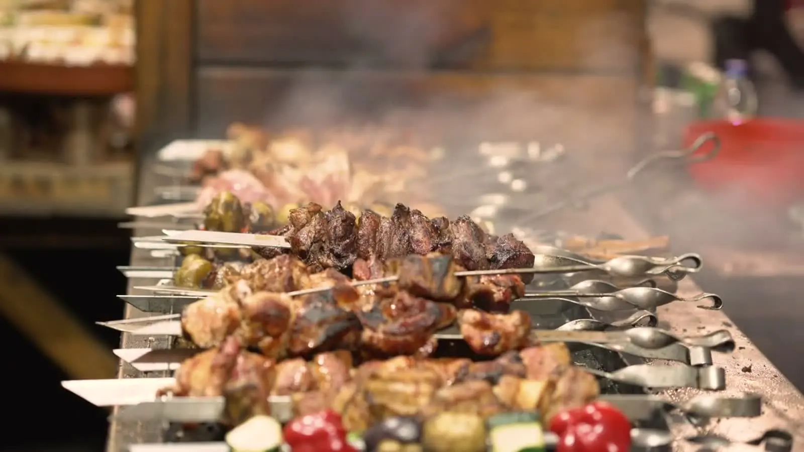 A grill loaded end to end with skewers